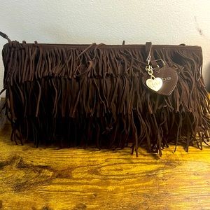 Brown string-leather Bebe bag. Beautiful with jeans. It’s sexy.